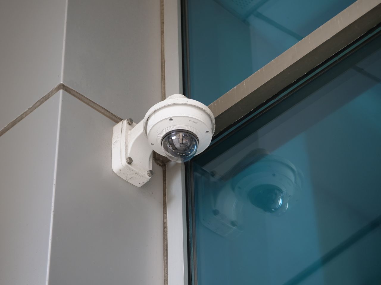 Crafting Captivating Headlines: Your awesome post title goes here Security camera mounted on a building corner for surveillance and safety.